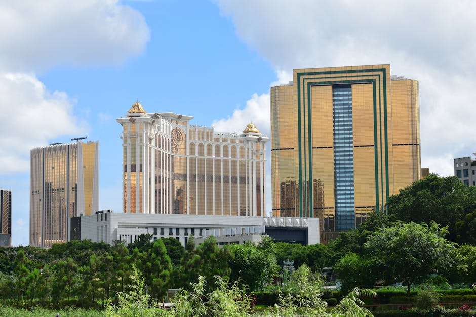 A vibrant view of Macau's skyline featuring iconic golden towers amidst lush greenery
