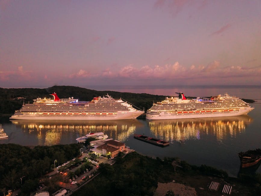 Two illuminated cruise ships docked at Coxen Hole, Honduras during twilight