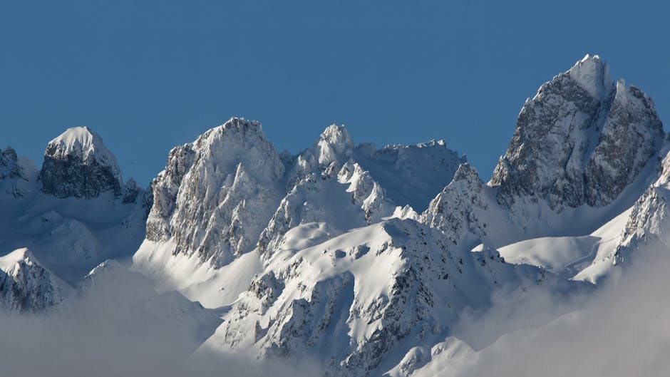 Stunning image of snow-capped mountains on a clear day, perfect for nature and winter themes.